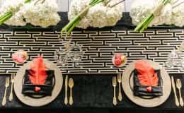 Sweetheart table with geometric runner, hydrangea and calla lily arrangements