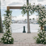 Wooden arch with white roses at Naples Bay Resort