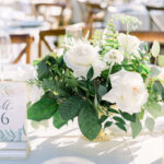 White roses as wedding centerpiece with custom table numbers