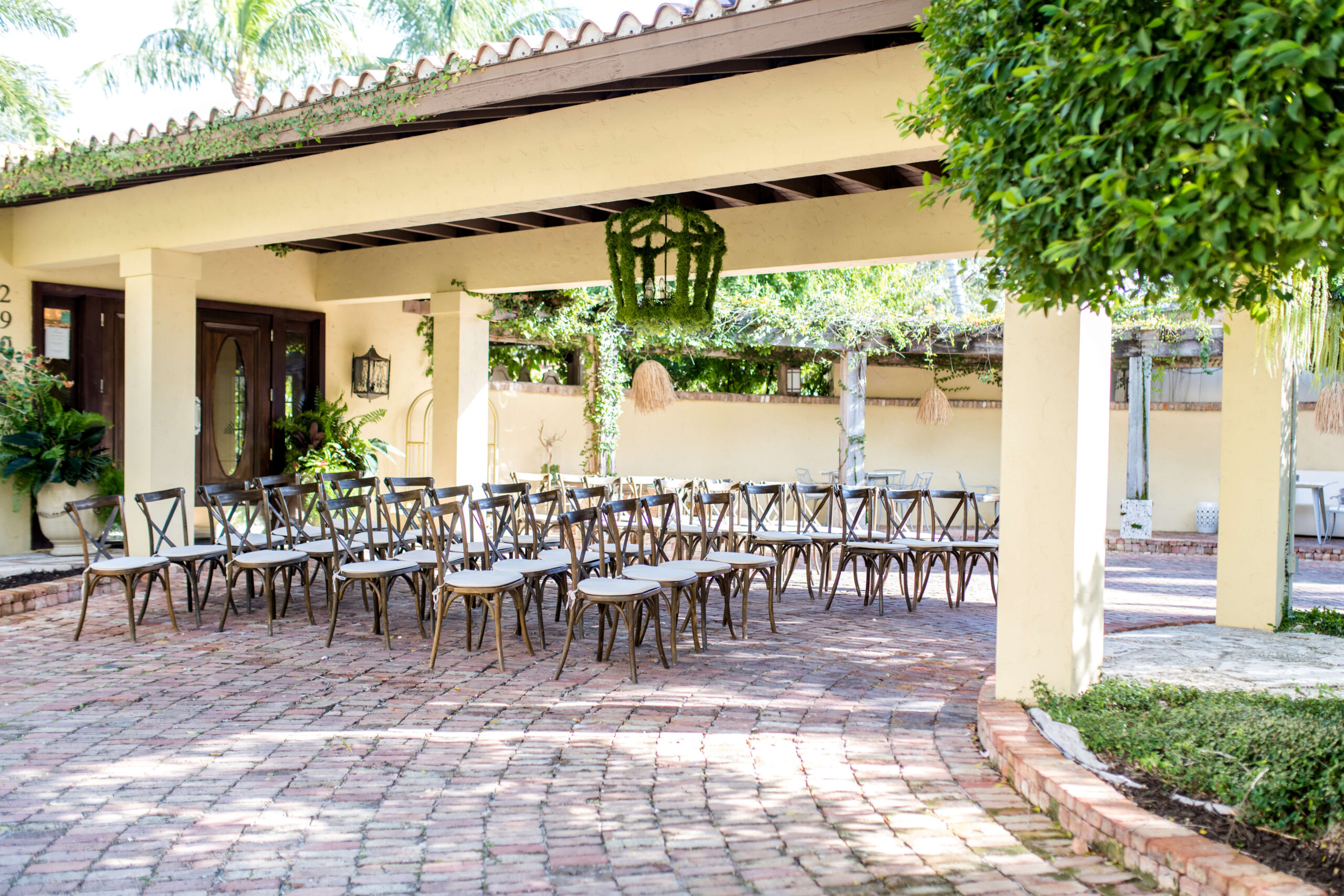 View of the porte cochere cermony set up with wooden chairs at Hotel Escalante